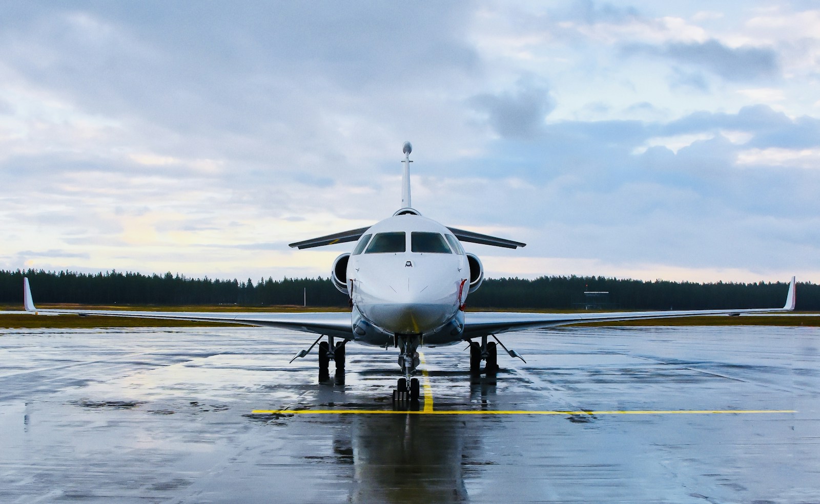 Illustrative private jet on a rain-swept apron